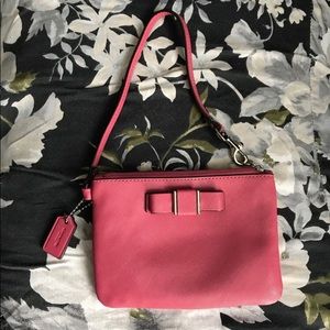 COACH pink wrist wallet with bow.